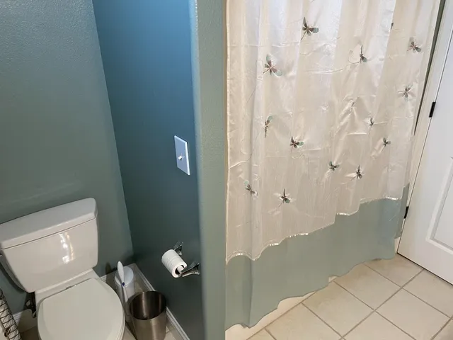a bathroom with a toilet and shower