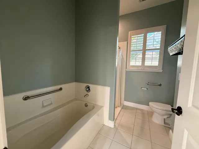 a bathroom with a bathtub and shower