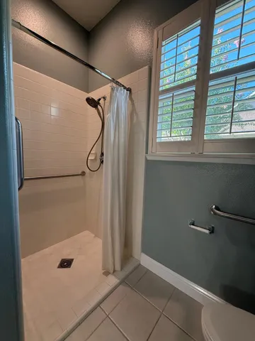 a bathroom with a glass shower door