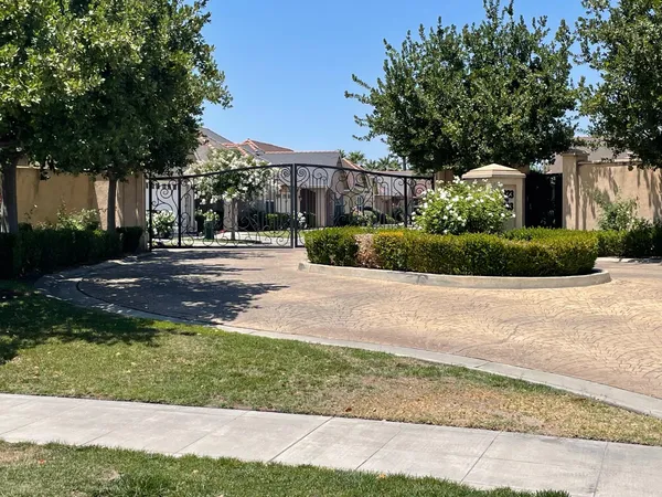a front view of a house with a yard and trees