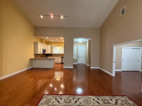 a kitchen with granite countertop cabinets stainless steel appliances and a sink