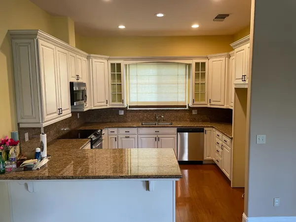 a kitchen with granite countertop cabinets and sink