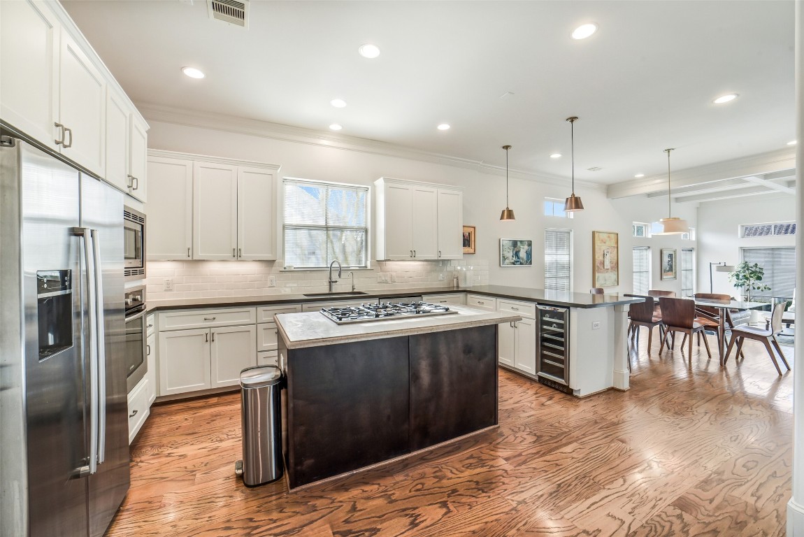 15943 Morgan Street Sugar Land, TX 77478 - Photo 12 of 41 a kitchen with kitchen island a counter top space a sink stainless steel appliances and cabinets