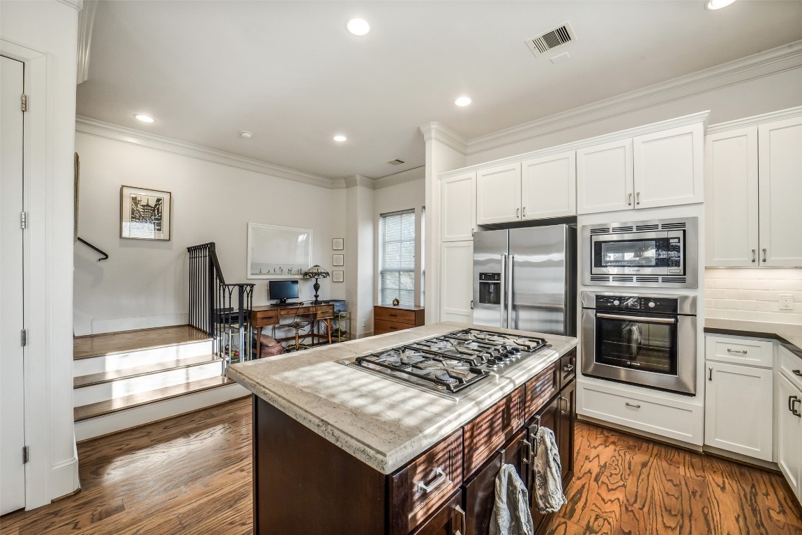 15943 Morgan Street Sugar Land, TX 77478 - Photo 14 of 41 a kitchen with a stove a refrigerator and a stove top oven