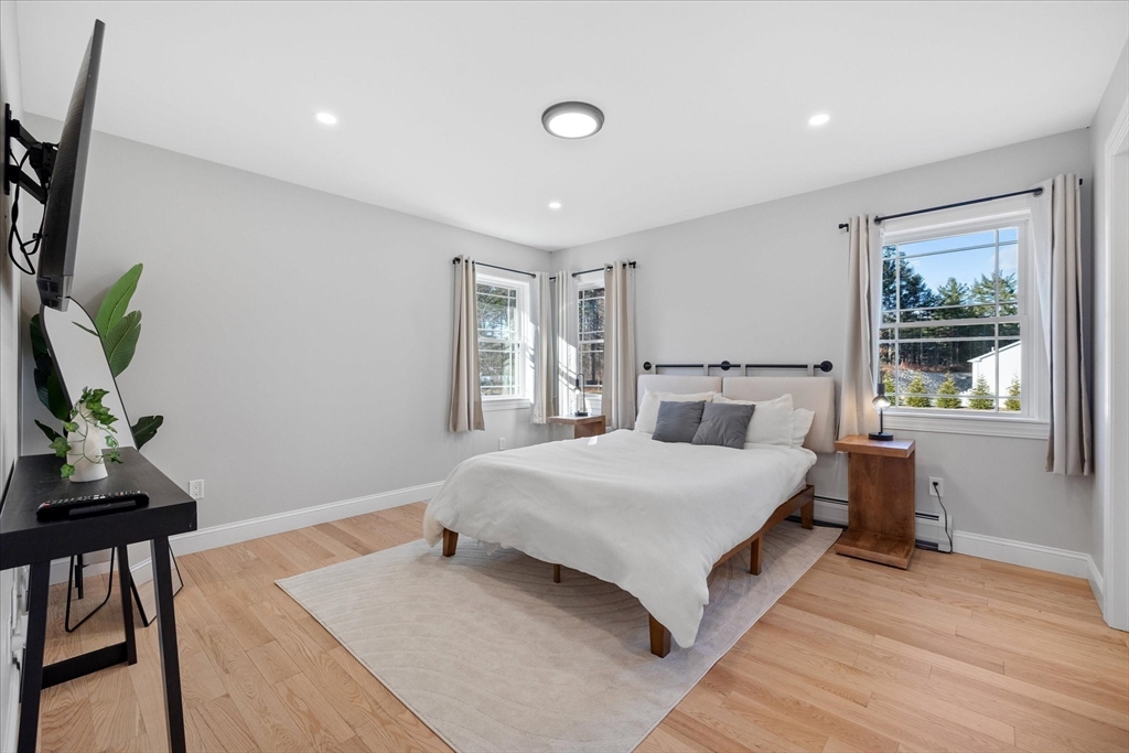 245 Brookside Road Athol, MA 01331 - Photo 12 of 27 a bedroom with a bed and a dresser next to a window