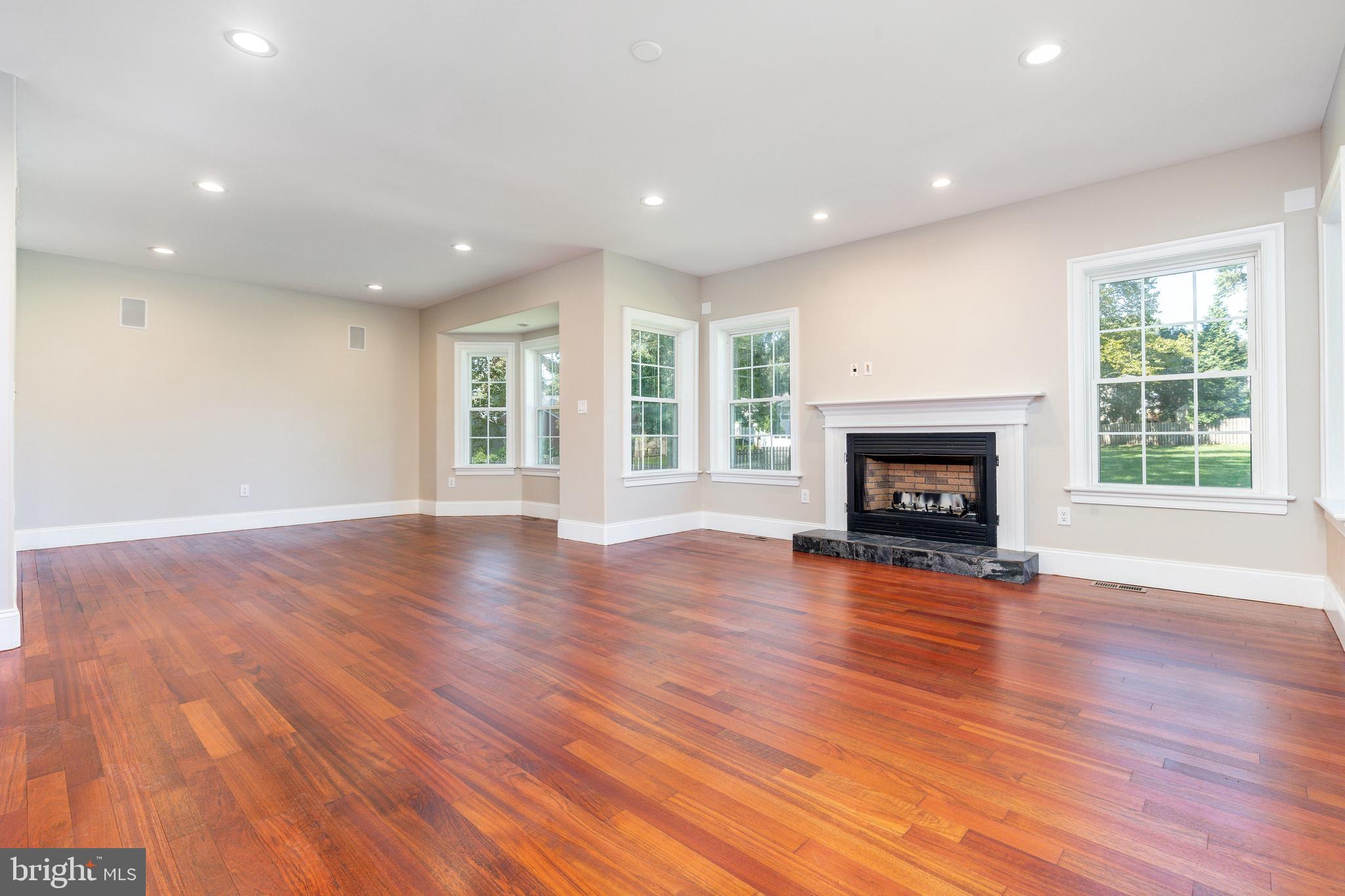 1060 Welsh Road Philadelphia, PA 19115 - Photo 11 of 62 an empty room with wooden floor fireplace and windows