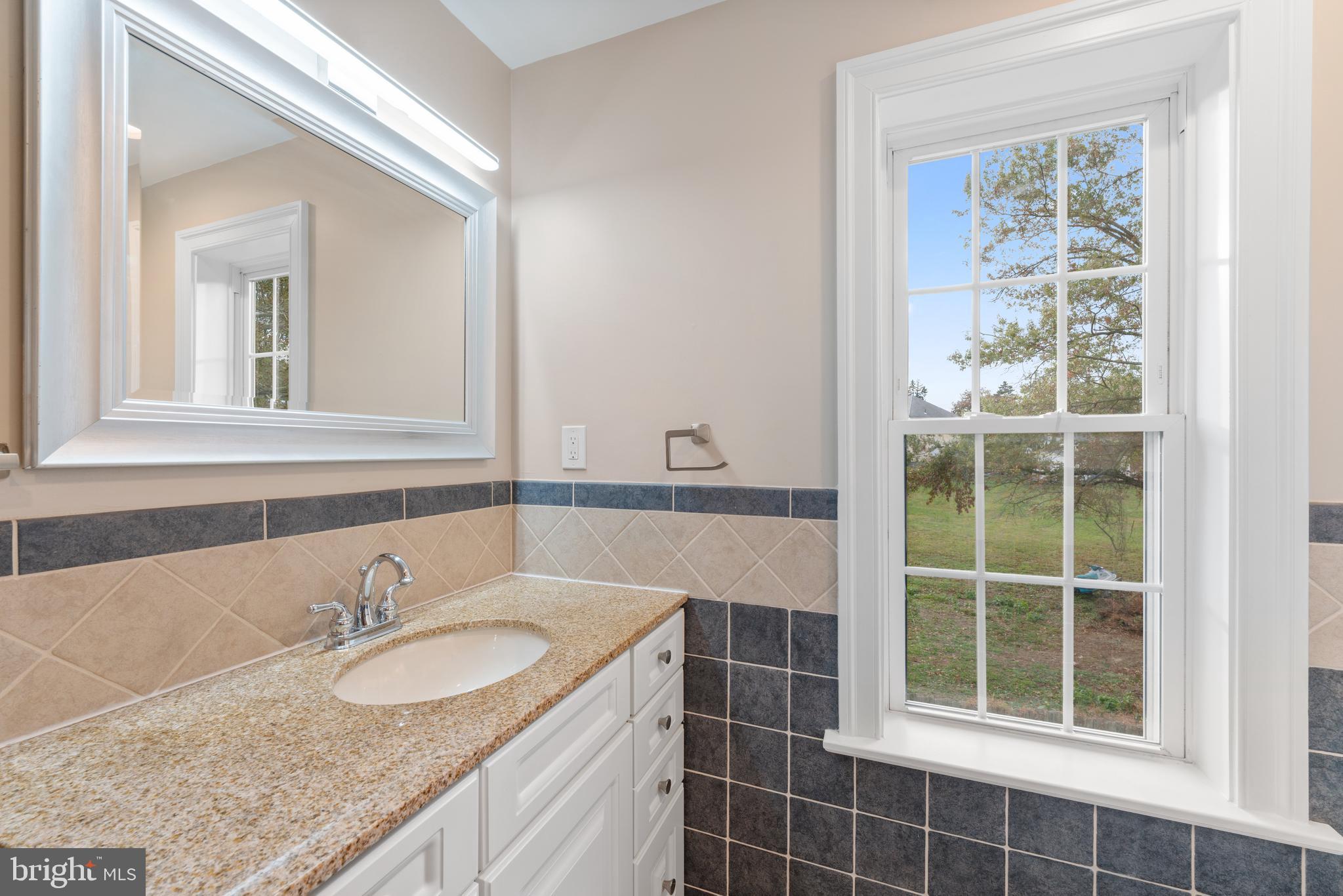 1060 Welsh Road Philadelphia, PA 19115 - Photo 17 of 62 a bathroom with a granite countertop sink and a mirror