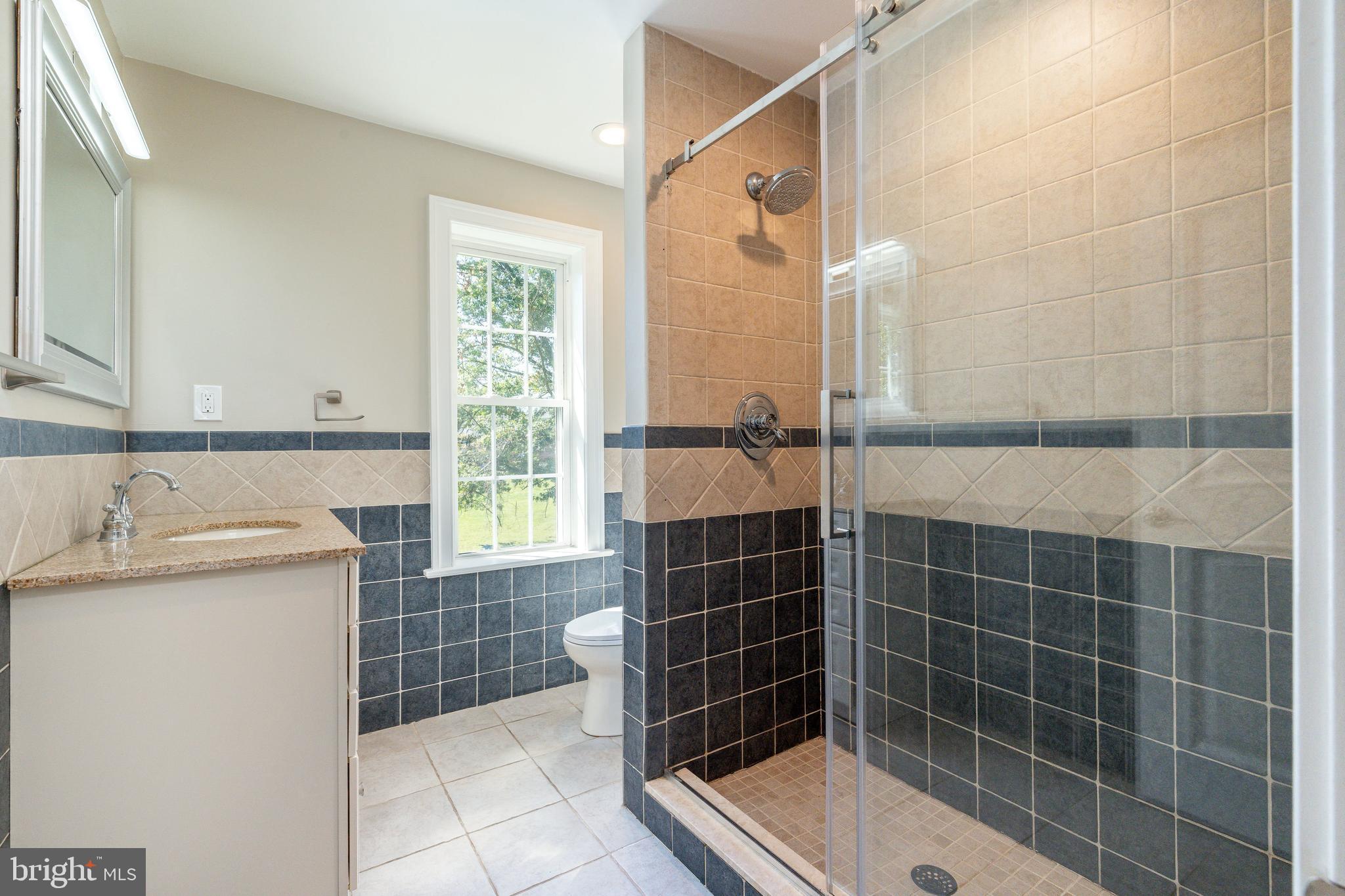 1060 Welsh Road Philadelphia, PA 19115 - Photo 18 of 62 a bathroom with a granite countertop sink a shower and a mirror