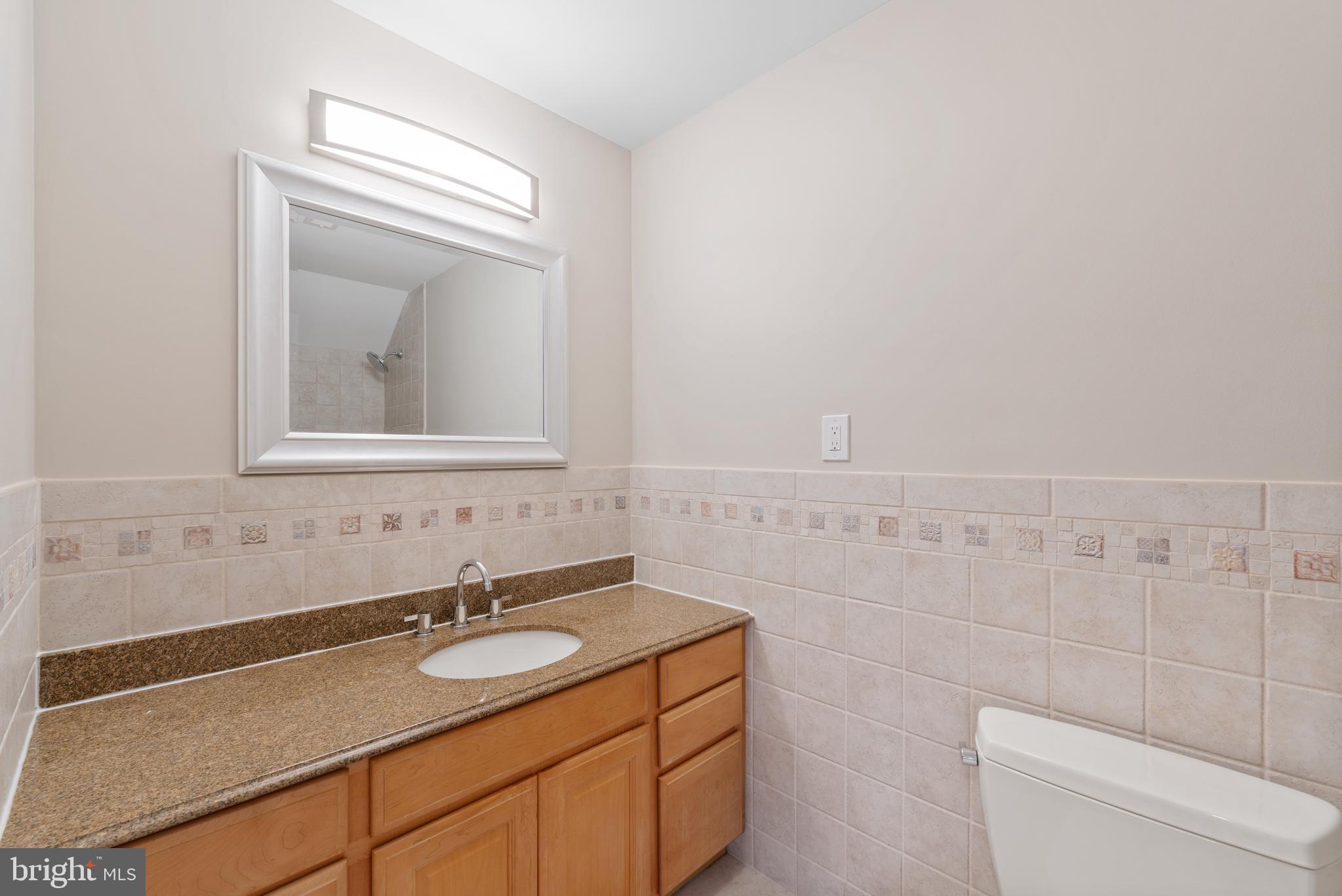 1060 Welsh Road Philadelphia, PA 19115 - Photo 27 of 62 a bathroom with a granite countertop sink and a mirror