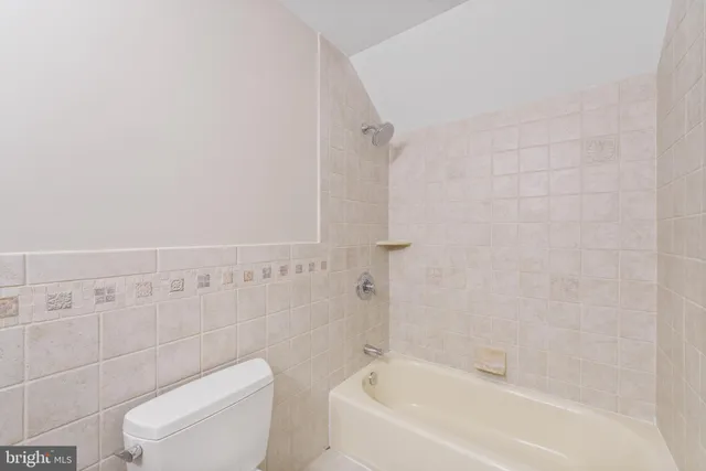 a spacious bathroom with double sink and a large mirror