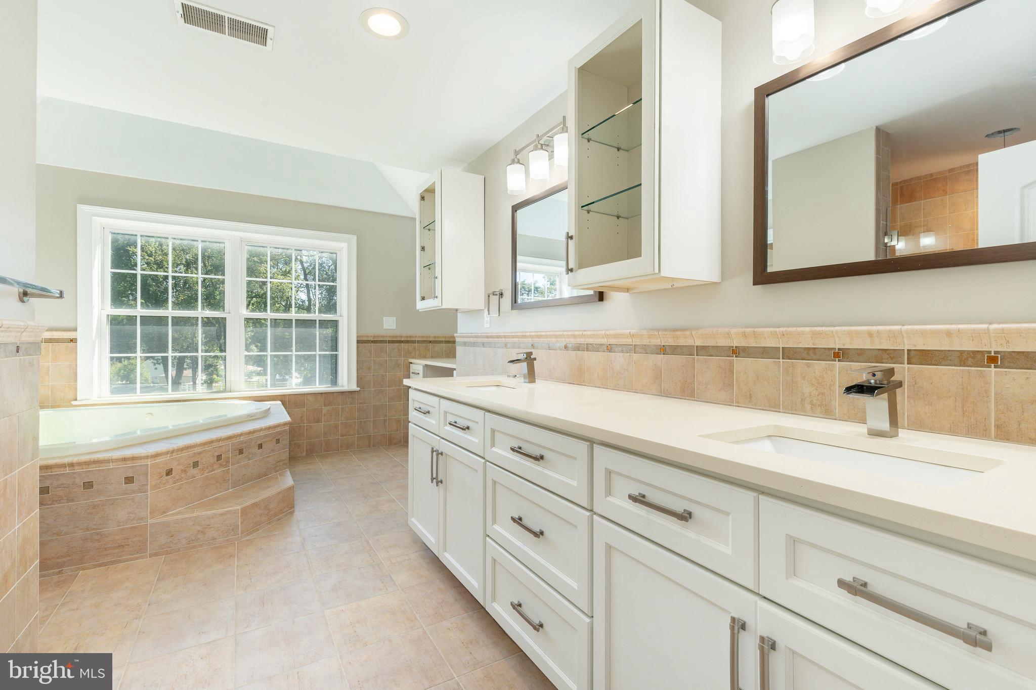 1060 Welsh Road Philadelphia, PA 19115 - Photo 33 of 62 a spacious bathroom with double sink and a large mirror