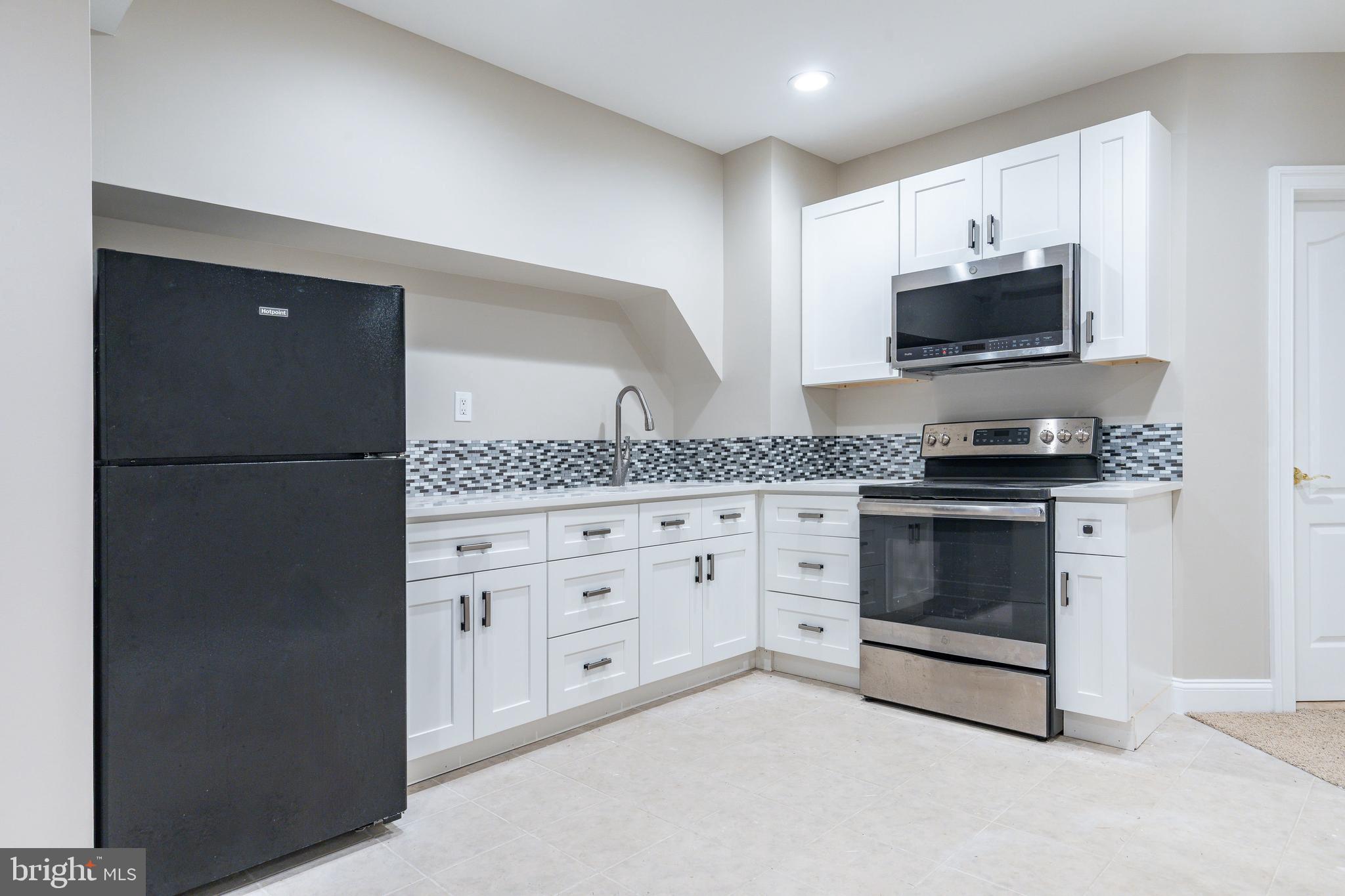 1060 Welsh Road Philadelphia, PA 19115 - Photo 36 of 62 a kitchen with stainless steel appliances granite countertop white cabinets a refrigerator and a stove