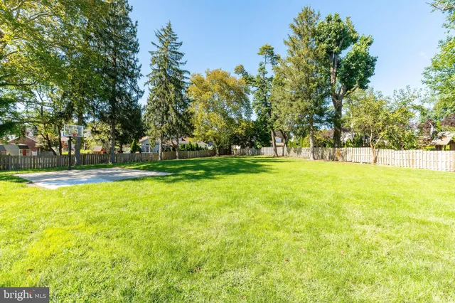 a aerial view of a house with a yard table and chairs