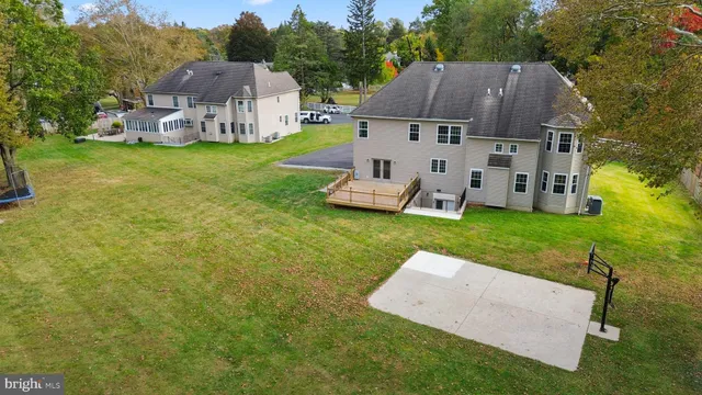 a view of a house with a yard and a basket ball ground