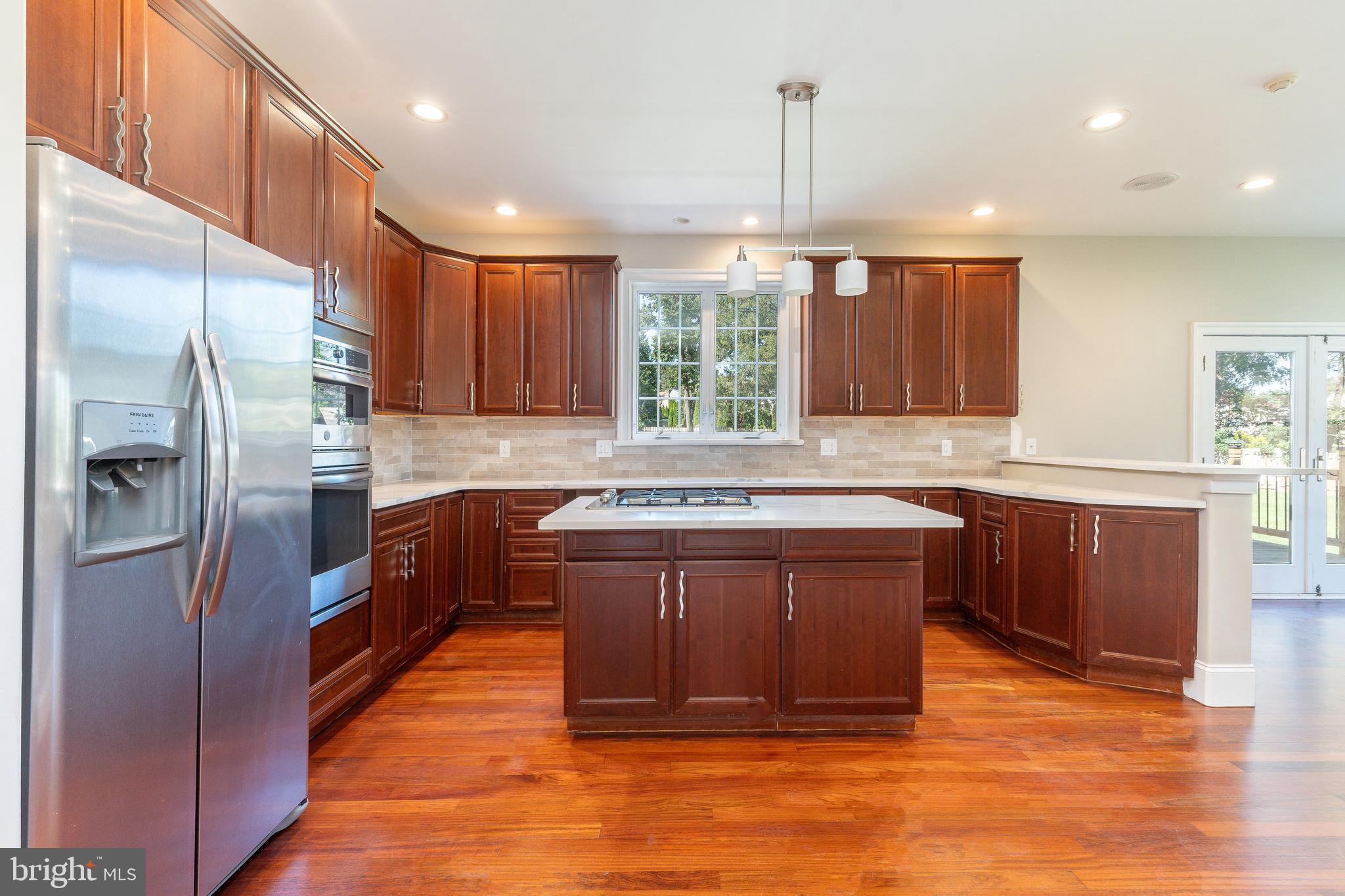1060 Welsh Road Philadelphia, PA 19115 - Photo 5 of 62 a kitchen with stainless steel appliances granite countertop a refrigerator a sink dishwasher a stove and a oven with wooden floor