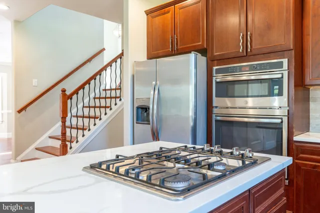 a kitchen with kitchen island a stove and a refrigerator