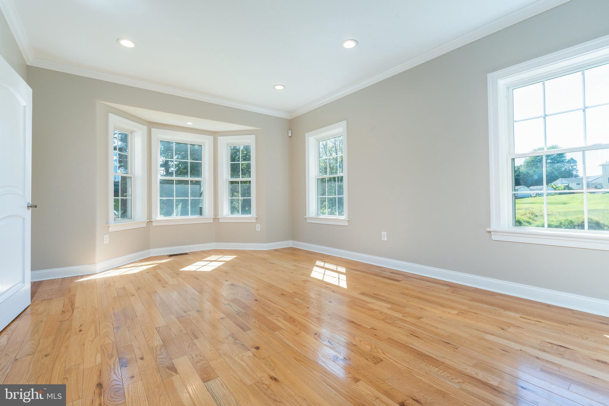 1060 Welsh Road Philadelphia, PA 19115 - Photo 8 of 62 an empty room with wooden floor and windows