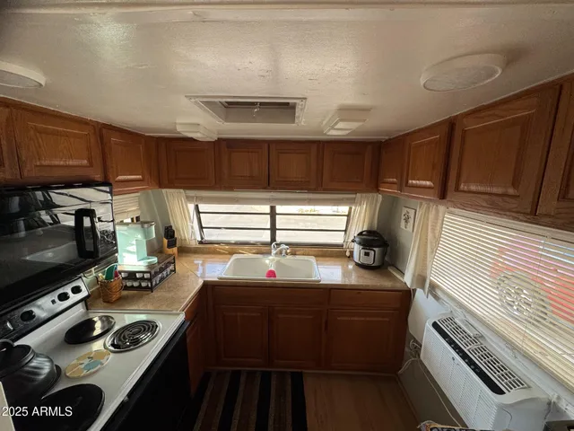 a kitchen with a stove a sink and a microwave
