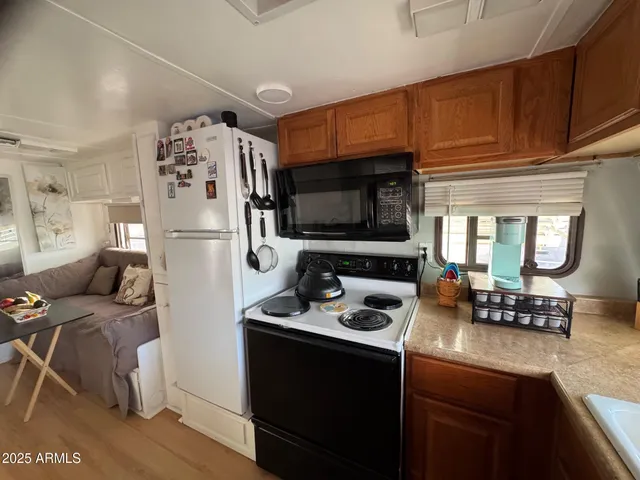 a kitchen with stainless steel appliances a refrigerator a stove a microwave and cabinets