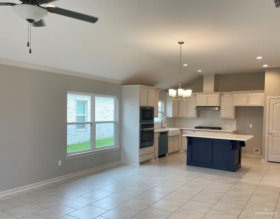 2373 Grove Lane Brownsville, TX 78526 - Photo 3 of 4 a kitchen with cabinets and window