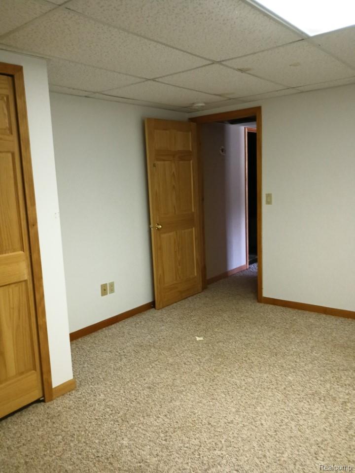 10374 Wilson Road Otisville, MI 48463 - Photo 70 of 99 Empty room with a drop ceiling and light colored carpet