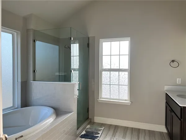 a bathroom with a bathtub and a window
