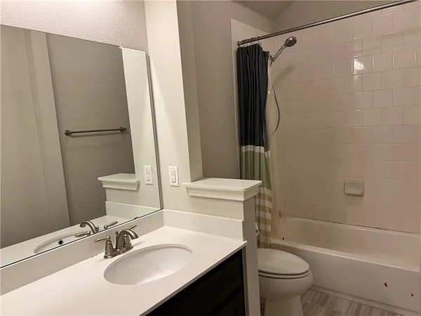 a white toilet sitting next to a bathroom sink