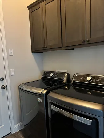 a view of a backyard with large trees and wooden fence