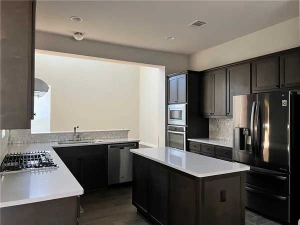 a kitchen with a sink stove and refrigerator