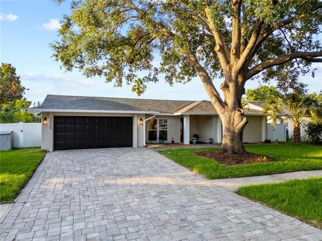 a front view of a house with yard and green space