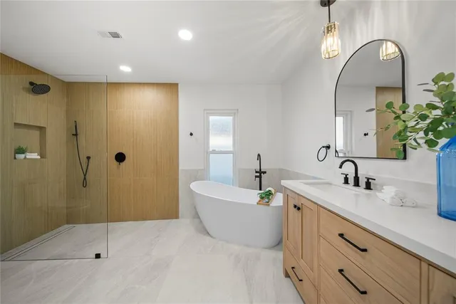 a bathroom with a double vanity sink mirror and shower