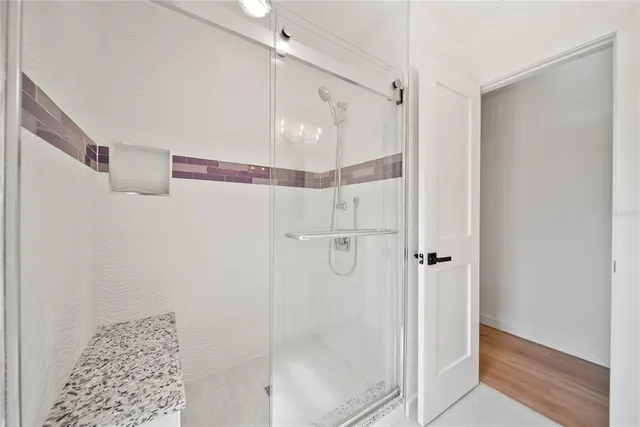 a bathroom with a glass shower door