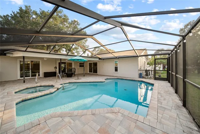 a room with pool table and windows