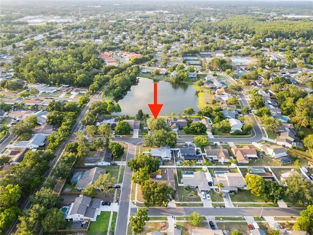 an aerial view of residential houses with outdoor space and river