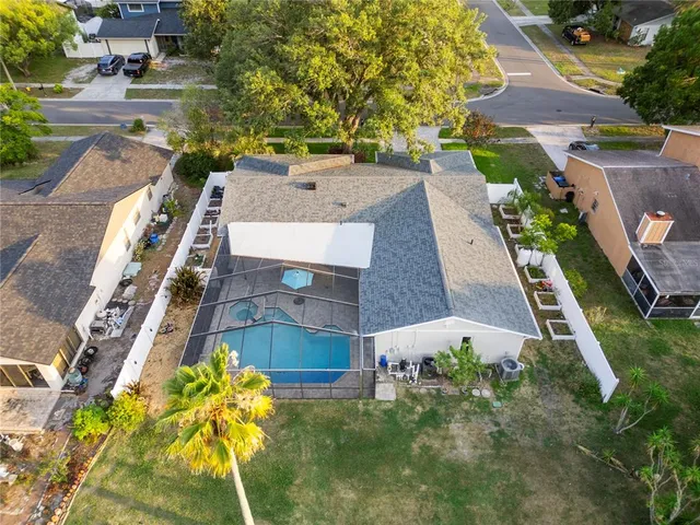 an aerial view of residential houses with outdoor space and swimming pool