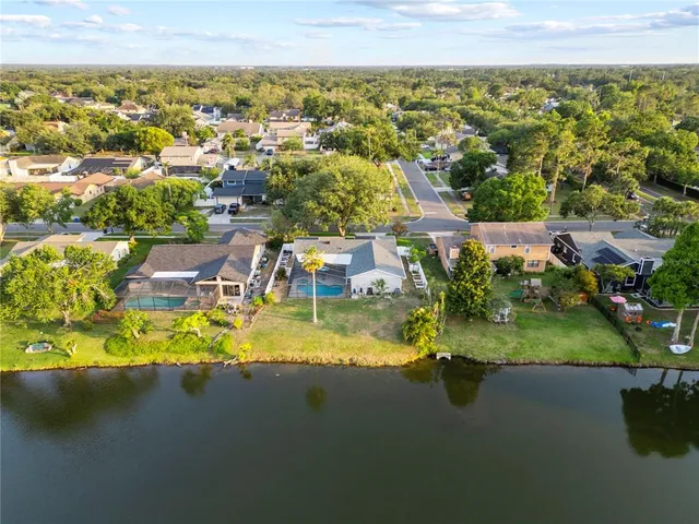 an aerial view of residential house with outdoor space and lake view