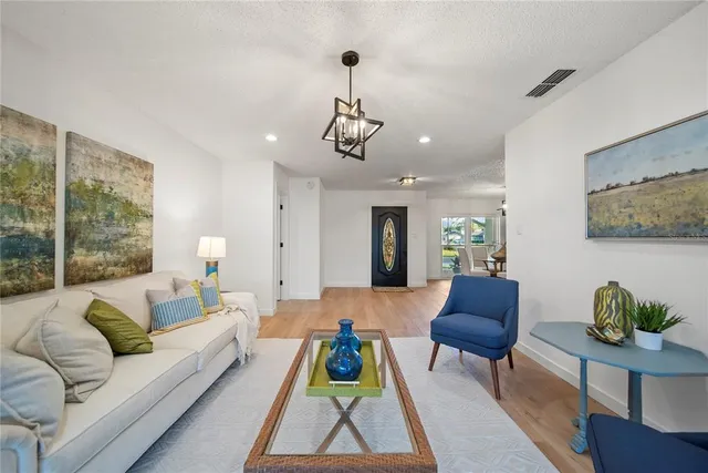 a living room with furniture and a chandelier
