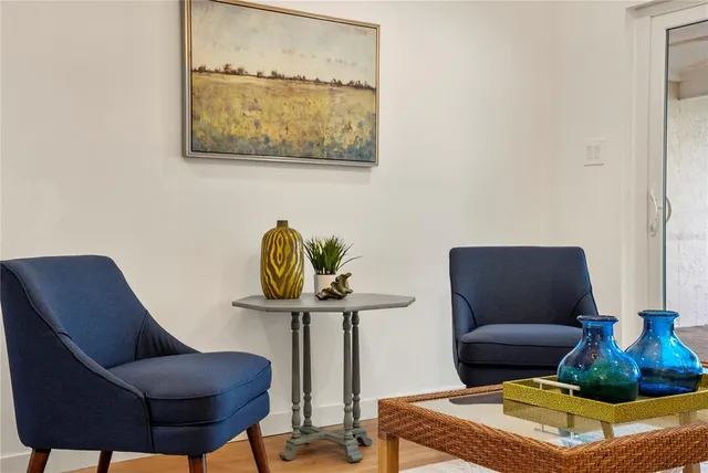 a living room with furniture and a chair