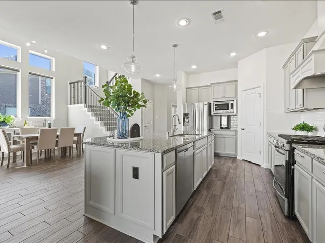 a kitchen with stainless steel appliances granite countertop counter space a sink and cabinets