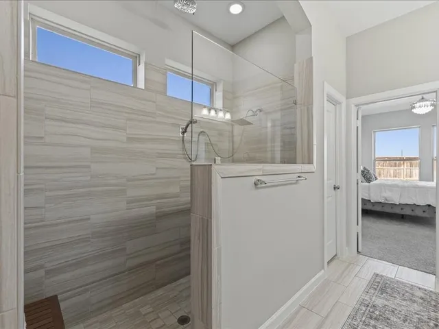 a bathroom with a shower and a sink
