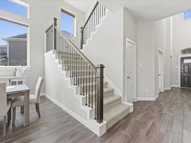 a view of entryway and hall with wooden floor