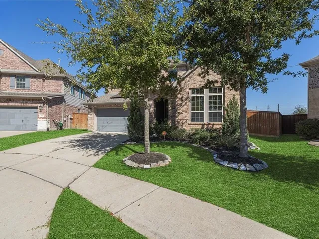 a front view of a house with a yard and a garage