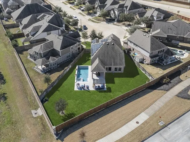 an aerial view of a house with a yard