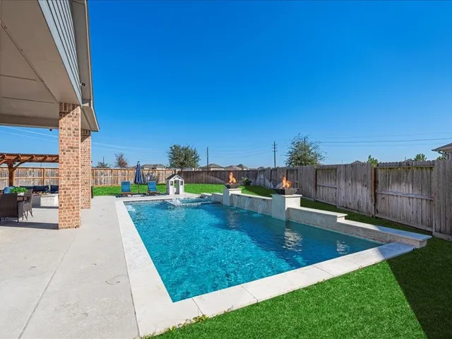 a view of a swimming pool with a patio