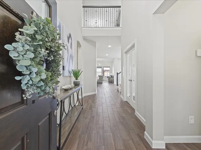 a view of a hallway view with wooden floor and staircase