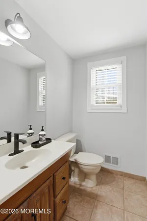 a bathroom with a sink toilet and a mirror