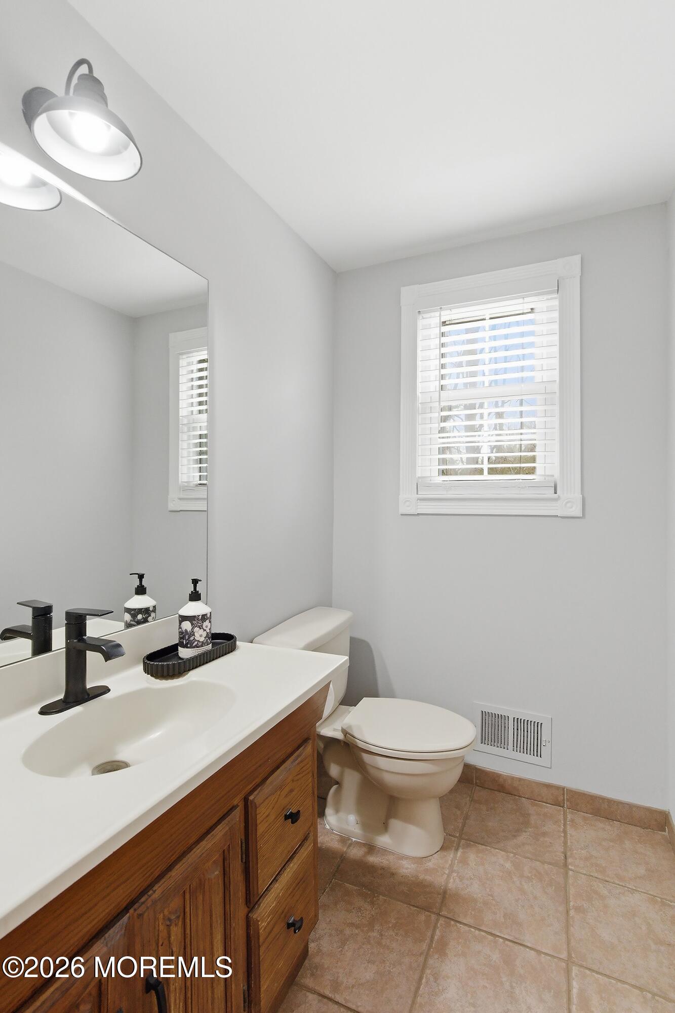 9 Bell Court Howell, NJ 07731 - Photo 14 of 30 a bathroom with a sink toilet and a mirror