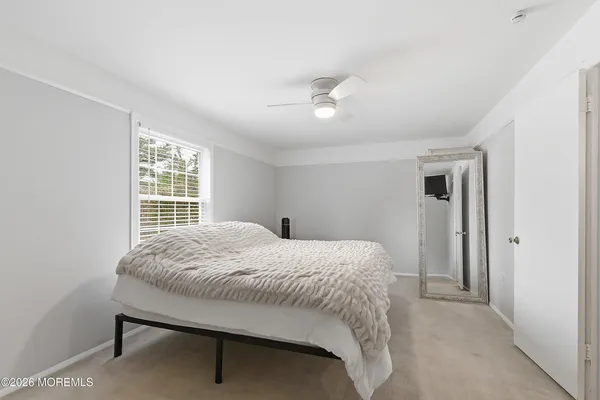 a bedroom with a large bed and a chandelier