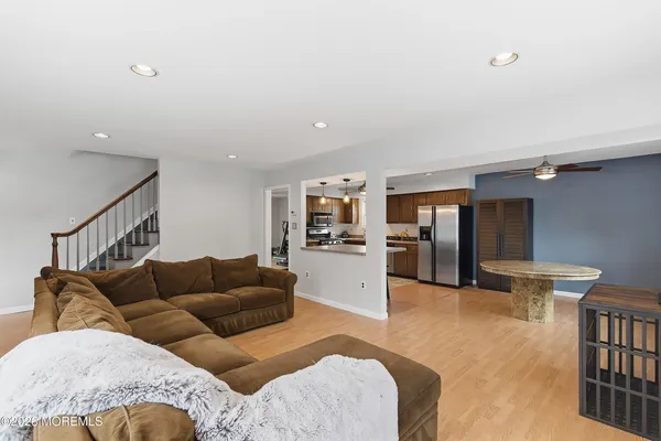 a living room with furniture and kitchen view