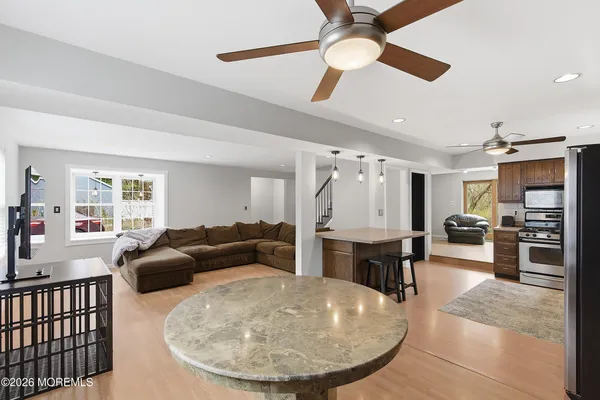 a living room with furniture and a dining table